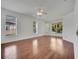 Bright bedroom with hardwood floors, ceiling fan, and multiple windows offering lots of natural light at 13130 Meergate Cir, Orlando, FL 32837