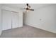 Bright bedroom with carpet, ceiling fan, closet and walls painted in a neutral color at 13130 Meergate Cir, Orlando, FL 32837