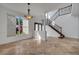Bright foyer features tile flooring, staircase with decorative iron railing, and an elegant light fixture at 13130 Meergate Cir, Orlando, FL 32837