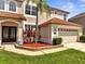 Exterior of the home showcasing the garage, front door, lawn, landscaping, and home address at 13130 Meergate Cir, Orlando, FL 32837