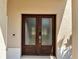Close up of the double front door and entrance with textured glass and dark wood trim at 13130 Meergate Cir, Orlando, FL 32837