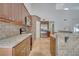 Modern kitchen with granite countertops, stainless steel appliances, and wooden cabinets at 13130 Meergate Cir, Orlando, FL 32837