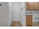 Laundry room with adjacent storage and access door to exterior at 13130 Meergate Cir, Orlando, FL 32837