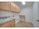 Functional laundry room with sink, cabinets, and ample counter space for folding at 13130 Meergate Cir, Orlando, FL 32837