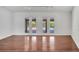 Open-concept living room showcasing wood floors and glass doors with pool view at 13130 Meergate Cir, Orlando, FL 32837