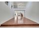 Open living room with hardwood flooring, staircase with iron railing, and chandelier at 13130 Meergate Cir, Orlando, FL 32837
