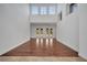 Spacious living room featuring hardwood flooring, high ceilings, and access to outdoor spaces at 13130 Meergate Cir, Orlando, FL 32837