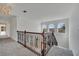 Upstairs loft area with carpet, iron railing and arched windows at 13130 Meergate Cir, Orlando, FL 32837