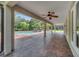 Spacious outdoor patio with exposed wooden ceiling fan, brick flooring, and screened-in pool and backyard at 13130 Meergate Cir, Orlando, FL 32837