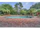 Swimming pool features brick patio, steps into the pool and lush landscaping, providing the perfect outdoor oasis at 13130 Meergate Cir, Orlando, FL 32837