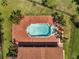 Aerial view of a beautiful pool, hot tub and brick patio, surrounded by lush tropical landscaping at 13130 Meergate Cir, Orlando, FL 32837