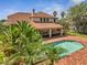 A luxurious backyard showcasing a sparkling pool, a relaxing hot tub, and a spacious brick patio at 13130 Meergate Cir, Orlando, FL 32837