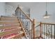 Staircase with wooden treads and ornate black iron railing leading to the upper level at 13130 Meergate Cir, Orlando, FL 32837