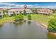 Aerial view of a home overlooking a tranquil lake, surrounded by lush landscaping and serene waterfront at 1628 Portofino Meadows Blvd, Orlando, FL 32824