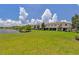 Lush green lawn extending to a serene lake, complemented by screened-in porches for outdoor enjoyment at 1628 Portofino Meadows Blvd, Orlando, FL 32824