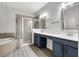 Bathroom featuring double sink vanity with framed mirrors, a large glass shower, and a soaking tub at 1628 Portofino Meadows Blvd, Orlando, FL 32824