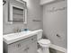 Cozy half-bathroom with modern fixtures, a vanity with storage, and a sleek lighted mirror above the sink at 1628 Portofino Meadows Blvd, Orlando, FL 32824