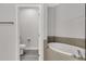 Bathroom view including a soaking tub with tile surround, and an enclosed toilet room at 1628 Portofino Meadows Blvd, Orlando, FL 32824