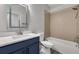 Bathroom featuring a large vanity with blue cabinets, white countertops, tub and shower combo, and updated fixtures at 1628 Portofino Meadows Blvd, Orlando, FL 32824