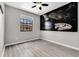Bedroom featuring modern flooring and a window with a view, plus Star Wars wall decor at 1628 Portofino Meadows Blvd, Orlando, FL 32824