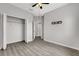 Bedroom featuring a walk-in closet and mounted tv hookups with gray walls and gray flooring at 1628 Portofino Meadows Blvd, Orlando, FL 32824
