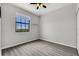 Bedroom with one large window, gray walls and gray flooring, and ceiling fan with lights at 1628 Portofino Meadows Blvd, Orlando, FL 32824