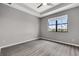 Bedroom with modern flooring and neutral walls, a tray ceiling, and a window view at 1628 Portofino Meadows Blvd, Orlando, FL 32824