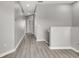 Hallway featuring modern flooring and neutral paint, leading to various rooms and closets at 1628 Portofino Meadows Blvd, Orlando, FL 32824