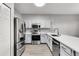 Modern kitchen with stainless steel appliances and gray cabinets plus a tiled backsplash and sleek countertops at 1628 Portofino Meadows Blvd, Orlando, FL 32824