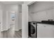 Laundry area with modern washer and dryer units, plus storage shelves and ample space at 1628 Portofino Meadows Blvd, Orlando, FL 32824