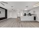 Stylish living space and kitchen area showcasing hardwood flooring and modern fixtures at 1628 Portofino Meadows Blvd, Orlando, FL 32824