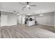 Spacious living room and kitchen with hardwood flooring and stainless steel appliances at 1628 Portofino Meadows Blvd, Orlando, FL 32824