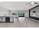Open-concept living room and kitchen area with modern finishes and hardwood floors at 1628 Portofino Meadows Blvd, Orlando, FL 32824