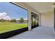 Enclosed patio with beautiful views of the community lake and landscaping at 1628 Portofino Meadows Blvd, Orlando, FL 32824