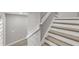 Staircase with wood treads and white risers featuring a modern handrail and neutral wall paint at 1628 Portofino Meadows Blvd, Orlando, FL 32824