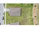 An aerial view of a home showcasing a large, green backyard and tree coverage at 172 Roseville Dr, Haines City, FL 33844