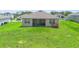 Spacious back yard featuring a covered patio, sliding glass doors, and a picnic table at 172 Roseville Dr, Haines City, FL 33844