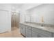 Modern bathroom with double vanity, granite countertops, and glass-enclosed shower at 172 Roseville Dr, Haines City, FL 33844