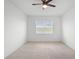 Unfurnished bedroom features neutral walls, carpeted floor, a window, and a ceiling fan at 172 Roseville Dr, Haines City, FL 33844