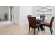 Cozy dining area featuring a round table, four chairs, and natural light from a window at 172 Roseville Dr, Haines City, FL 33844