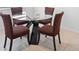 Elegant dining area featuring a glass-top table with modern chairs and stylish design at 172 Roseville Dr, Haines City, FL 33844