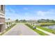 Scenic entrance to Tarpon Bay featuring white trellis accents and manicured landscaping at 172 Roseville Dr, Haines City, FL 33844