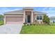 Inviting single-story home featuring a brick driveway and a welcoming covered entrance at 172 Roseville Dr, Haines City, FL 33844