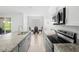 Modern kitchen featuring granite countertops, stainless steel appliances, and tile flooring at 172 Roseville Dr, Haines City, FL 33844