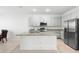 Modern kitchen featuring granite countertops, stainless steel appliances, and a central island at 172 Roseville Dr, Haines City, FL 33844