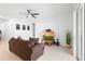 Inviting living room with tile floors, ceiling fan, and sliding glass door to the backyard at 172 Roseville Dr, Haines City, FL 33844