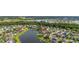 Aerial shot of homes situated on winding waterfronts amidst mature trees and established neighborhoods at 1760 Boat Launch Rd, Kissimmee, FL 34746