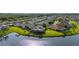 Drone image of waterfront homes in a suburban community next to a lake and forest at 1760 Boat Launch Rd, Kissimmee, FL 34746