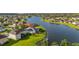 Aerial view of a waterside home boasting solar panels, screened in patio, and lush green backyard at 1760 Boat Launch Rd, Kissimmee, FL 34746