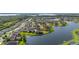 Drone image of waterfront homes in a suburban community next to a lake and forest at 1760 Boat Launch Rd, Kissimmee, FL 34746